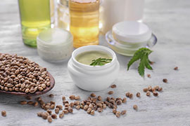 Beautiful composition with jar of hemp lotion on wooden background