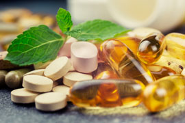 pills and multivitamins on a dark background, closeup